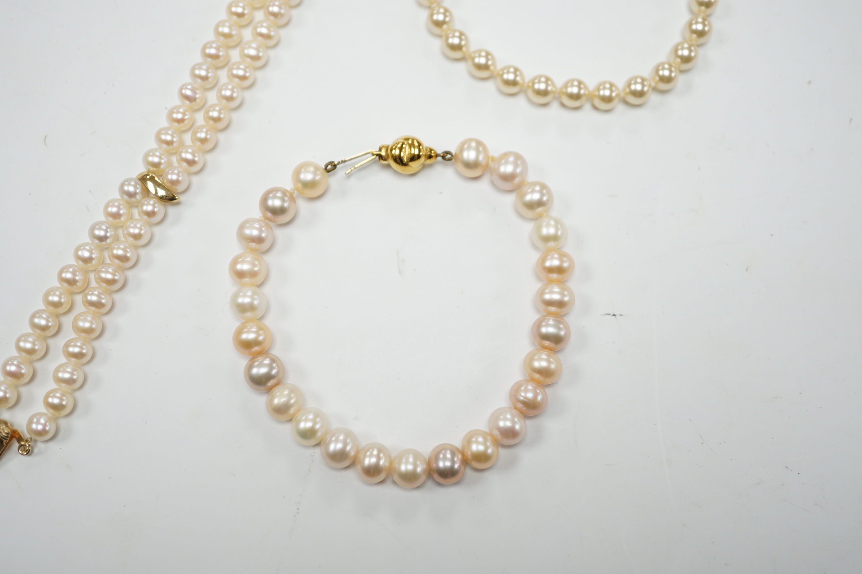 A modern double strand cultured pearl bracelet, with 14k clasp, 18cm, one other cultured pearl bracelet with 375 clasp and a simulated pearl bracelet.